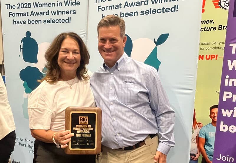 An image of Renee holding an award.